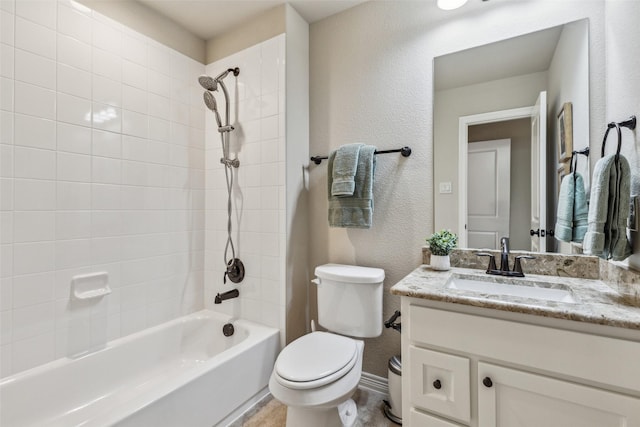 full bath featuring vanity, baseboards, shower / tub combination, toilet, and a textured wall