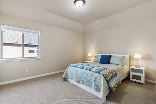 carpeted bedroom featuring baseboards