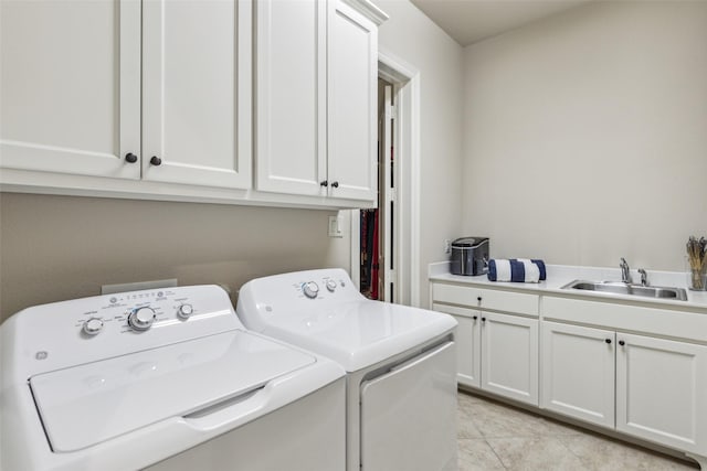 laundry area featuring washer and clothes dryer, light tile patterned floors, cabinet space, and a sink