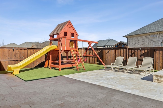 view of jungle gym featuring a patio area and a fenced backyard