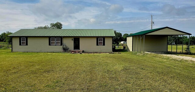 back of house with a carport and a yard