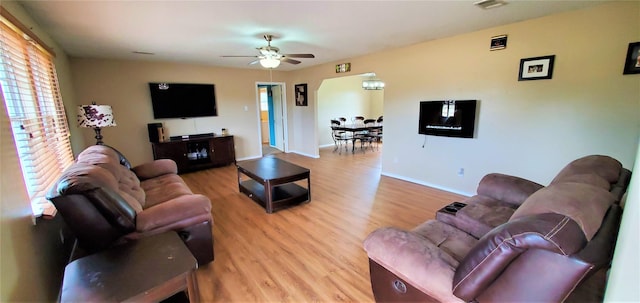 living room with ceiling fan and light wood-type flooring