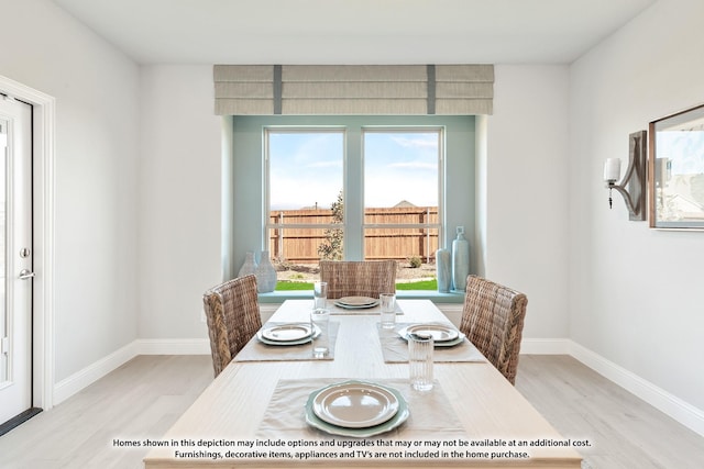 dining area with a healthy amount of sunlight and light hardwood / wood-style floors