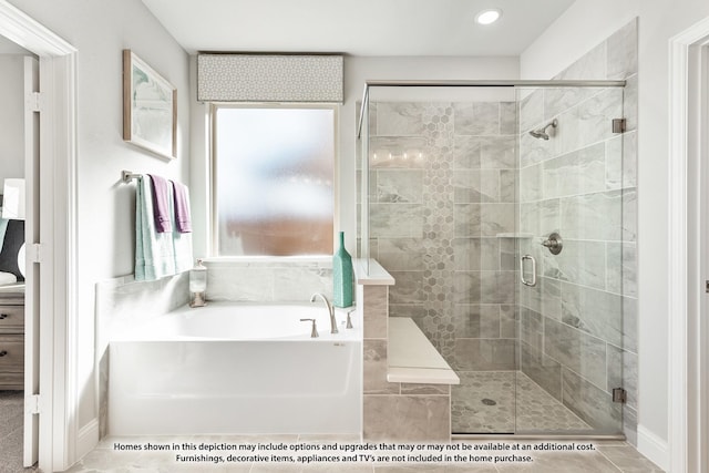 bathroom featuring tile patterned floors and separate shower and tub