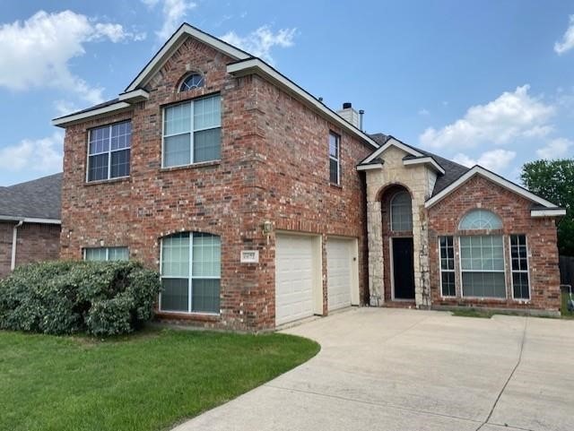 view of front property with a garage and a front yard