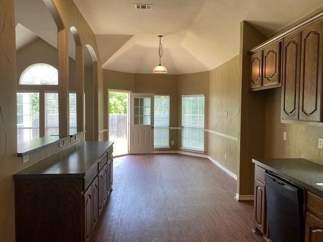 kitchen featuring decorative backsplash, plenty of natural light, lofted ceiling, and black dishwasher