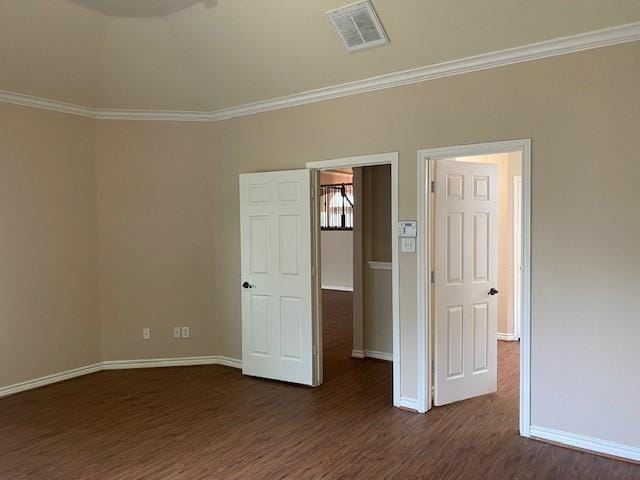 spare room with crown molding and dark hardwood / wood-style floors