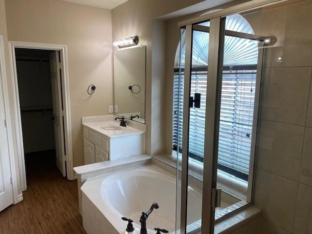 bathroom featuring hardwood / wood-style floors, vanity, and a bathtub