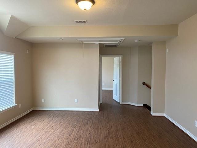 unfurnished room featuring dark wood-type flooring