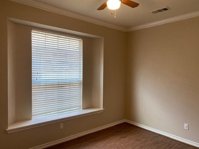 unfurnished room with dark hardwood / wood-style flooring, ceiling fan, and crown molding