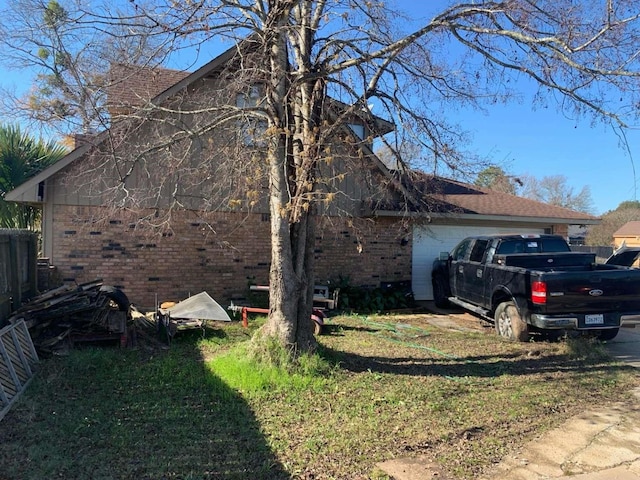 view of property exterior featuring a garage and a lawn