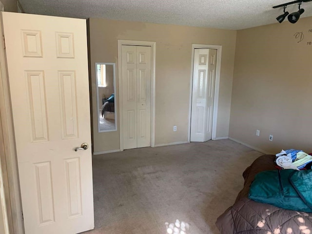 unfurnished bedroom with light carpet and a textured ceiling