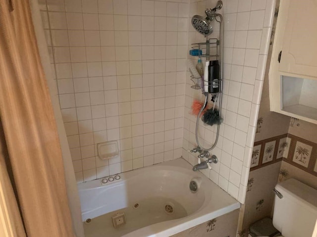 bathroom with toilet and shower / bath combo with shower curtain