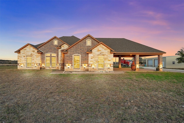 view of front facade with a yard, a garage, and a carport