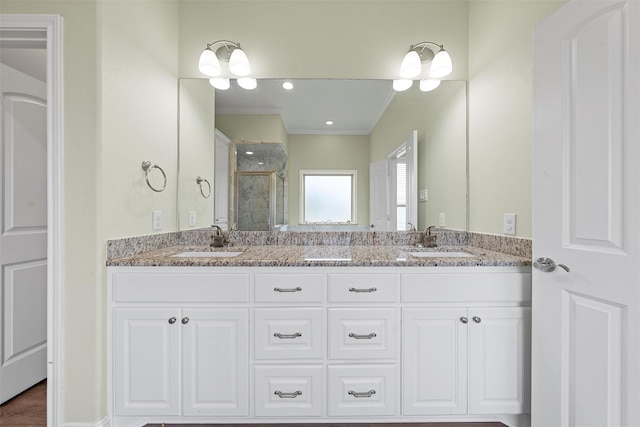 bathroom featuring crown molding, vanity, and walk in shower