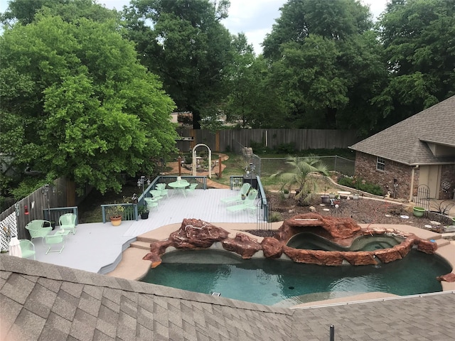 view of swimming pool featuring an in ground hot tub and a patio