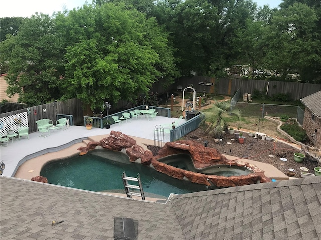 view of swimming pool featuring an in ground hot tub and a patio area