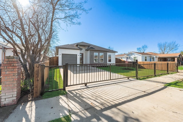 view of front of home with a front yard and a garage