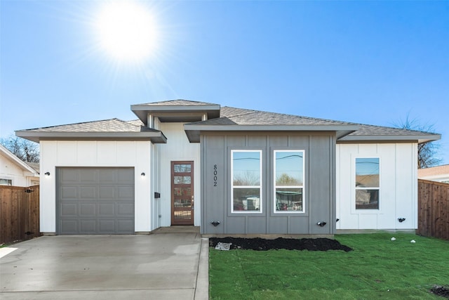 view of front of property featuring a garage and a front lawn