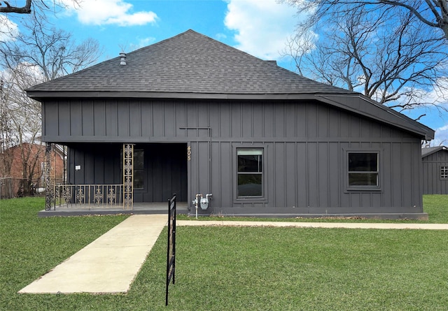 back of property with a porch and a yard