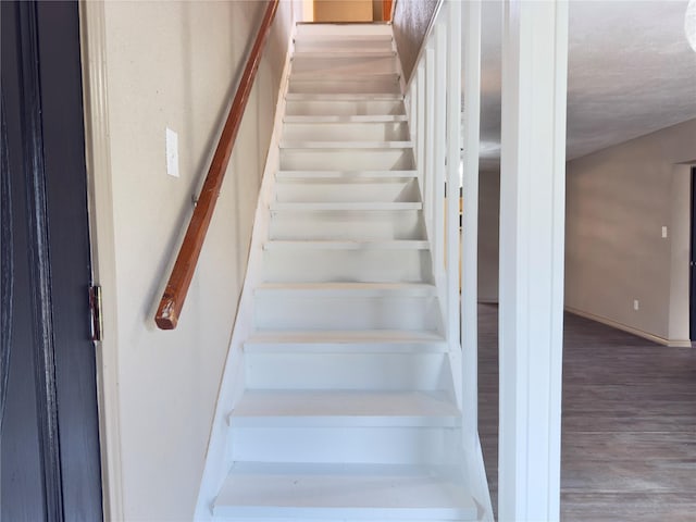 staircase featuring wood-type flooring