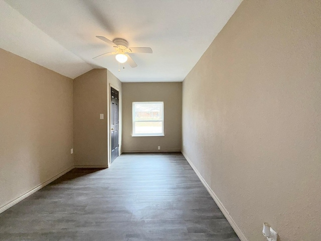 unfurnished room with ceiling fan, dark hardwood / wood-style flooring, and vaulted ceiling