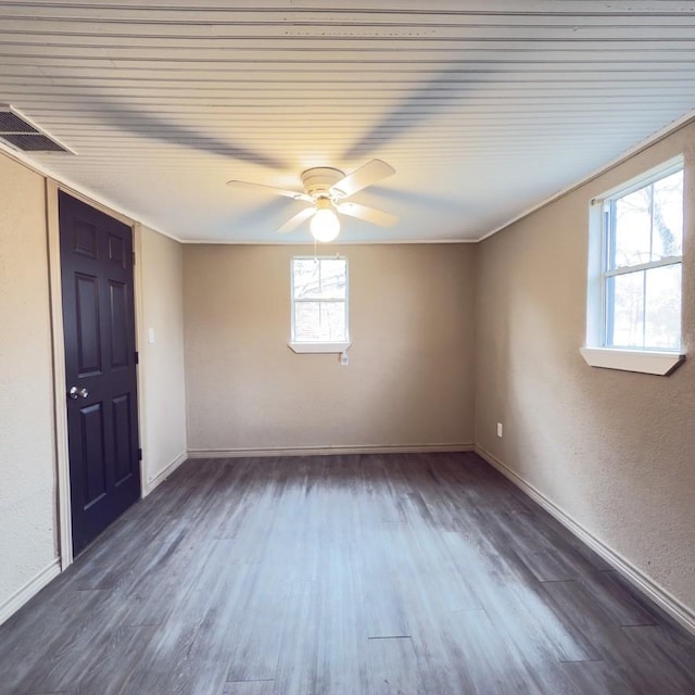 unfurnished room with ceiling fan and dark wood-type flooring