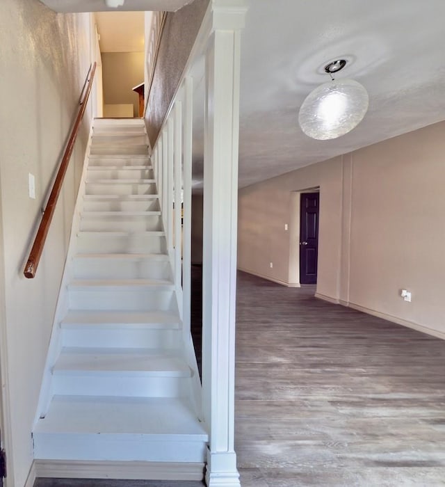 staircase with hardwood / wood-style floors