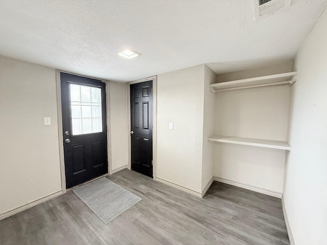 entryway featuring a textured ceiling and hardwood / wood-style floors