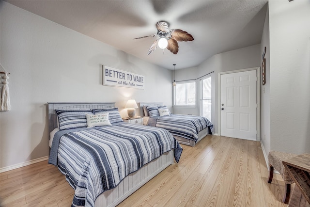 bedroom with ceiling fan and hardwood / wood-style floors