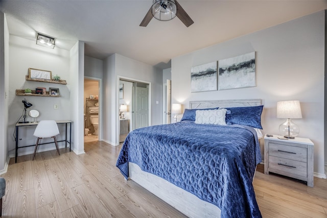 bedroom with connected bathroom, ceiling fan, and light hardwood / wood-style flooring