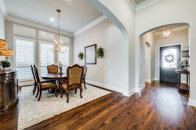 dining room with a notable chandelier, dark hardwood / wood-style flooring, and ornamental molding