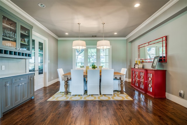 dining space with ornamental molding, dark wood-type flooring, and a healthy amount of sunlight