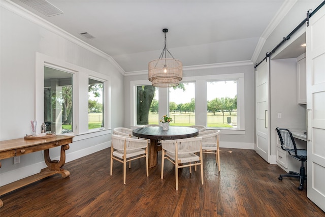 dining space featuring a barn door, dark hardwood / wood-style flooring, lofted ceiling, and ornamental molding