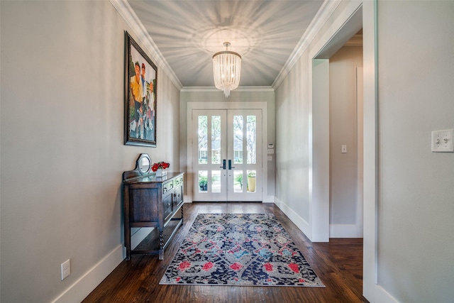 entrance foyer with french doors, dark hardwood / wood-style flooring, an inviting chandelier, and ornamental molding