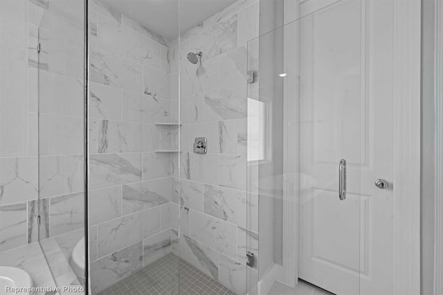 bathroom featuring a shower with shower door