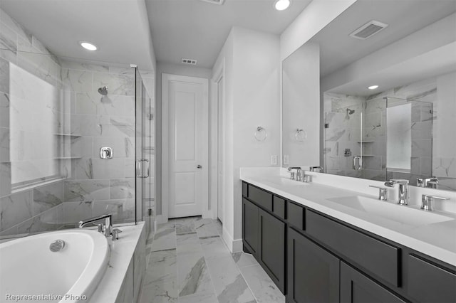 bathroom featuring separate shower and tub and vanity