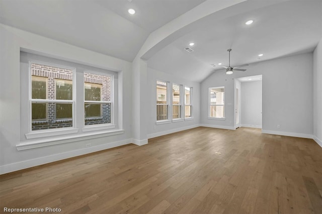 unfurnished living room featuring vaulted ceiling, ceiling fan, and hardwood / wood-style flooring