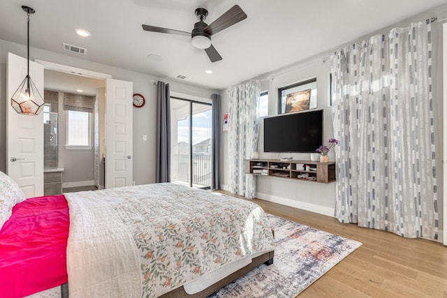 bedroom featuring wood-type flooring, access to outside, ensuite bath, and ceiling fan