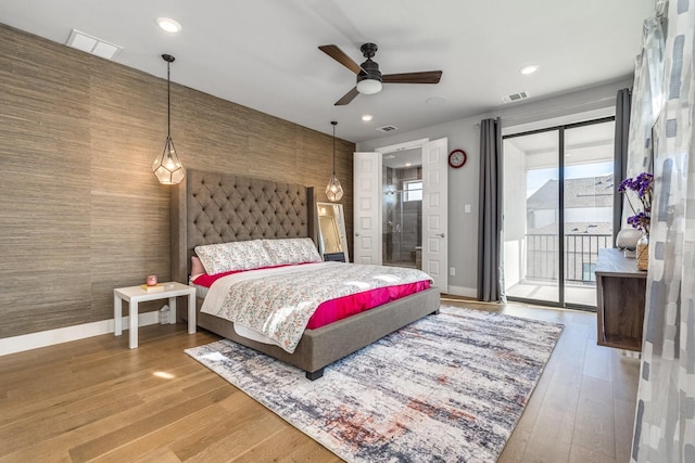 bedroom featuring access to exterior, hardwood / wood-style flooring, and ceiling fan