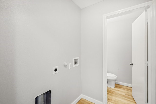 clothes washing area with washer hookup, wood-type flooring, hookup for an electric dryer, and gas dryer hookup