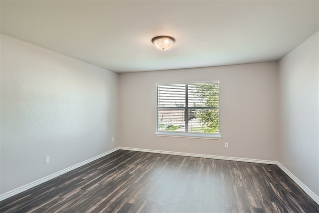 unfurnished room with dark hardwood / wood-style floors