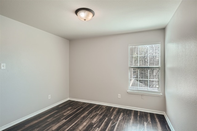 unfurnished room with dark hardwood / wood-style floors