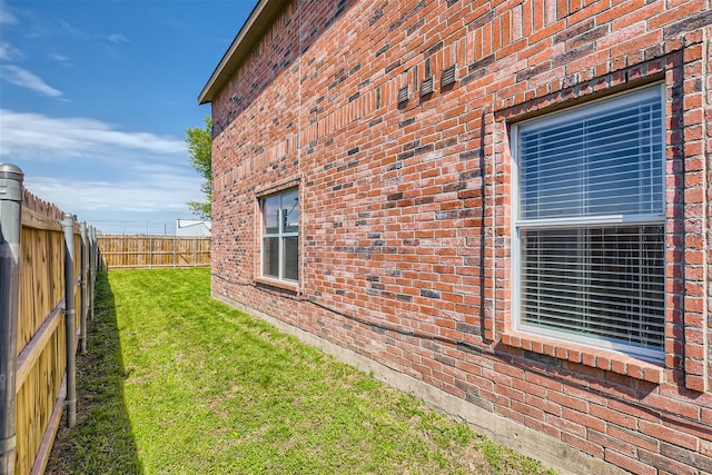 view of side of property with a lawn