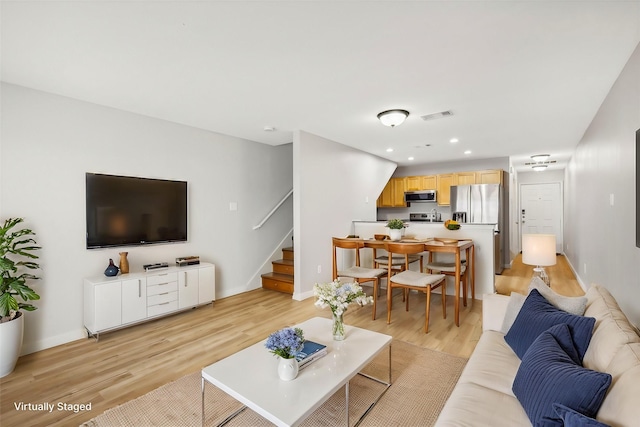 living room with light hardwood / wood-style floors