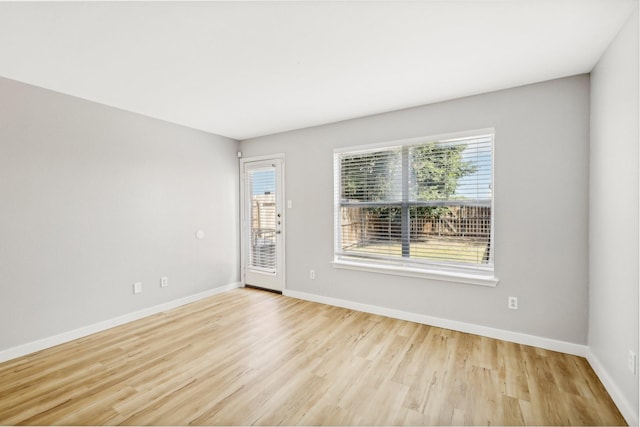 unfurnished room featuring plenty of natural light and light wood-type flooring