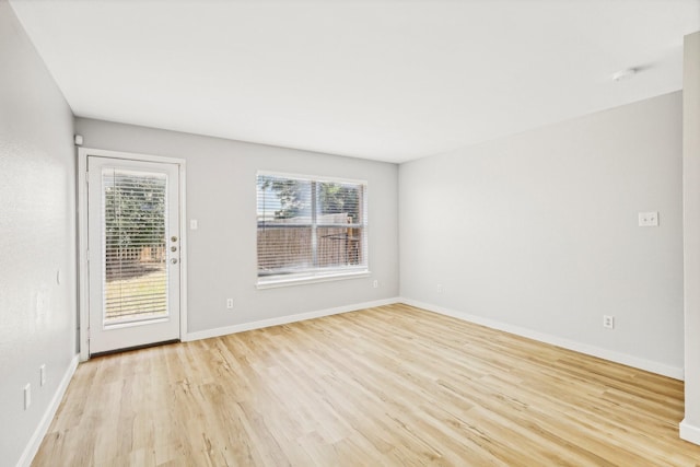 unfurnished room with light hardwood / wood-style flooring