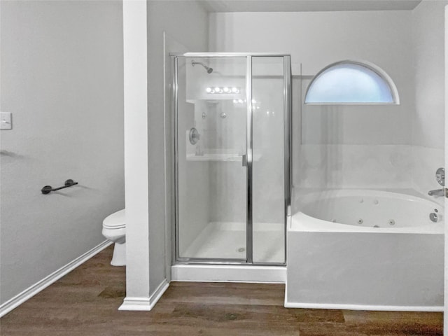 bathroom featuring hardwood / wood-style floors, toilet, and plus walk in shower