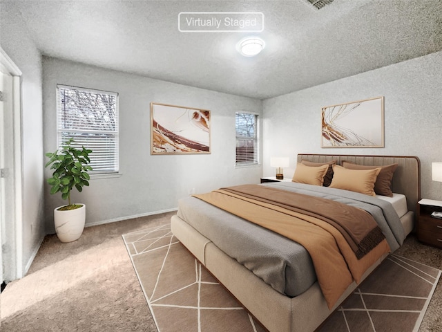 carpeted bedroom featuring a textured ceiling