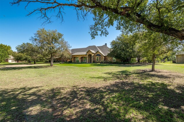 ranch-style home with a front lawn